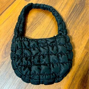 Small black quilted puffer purse.